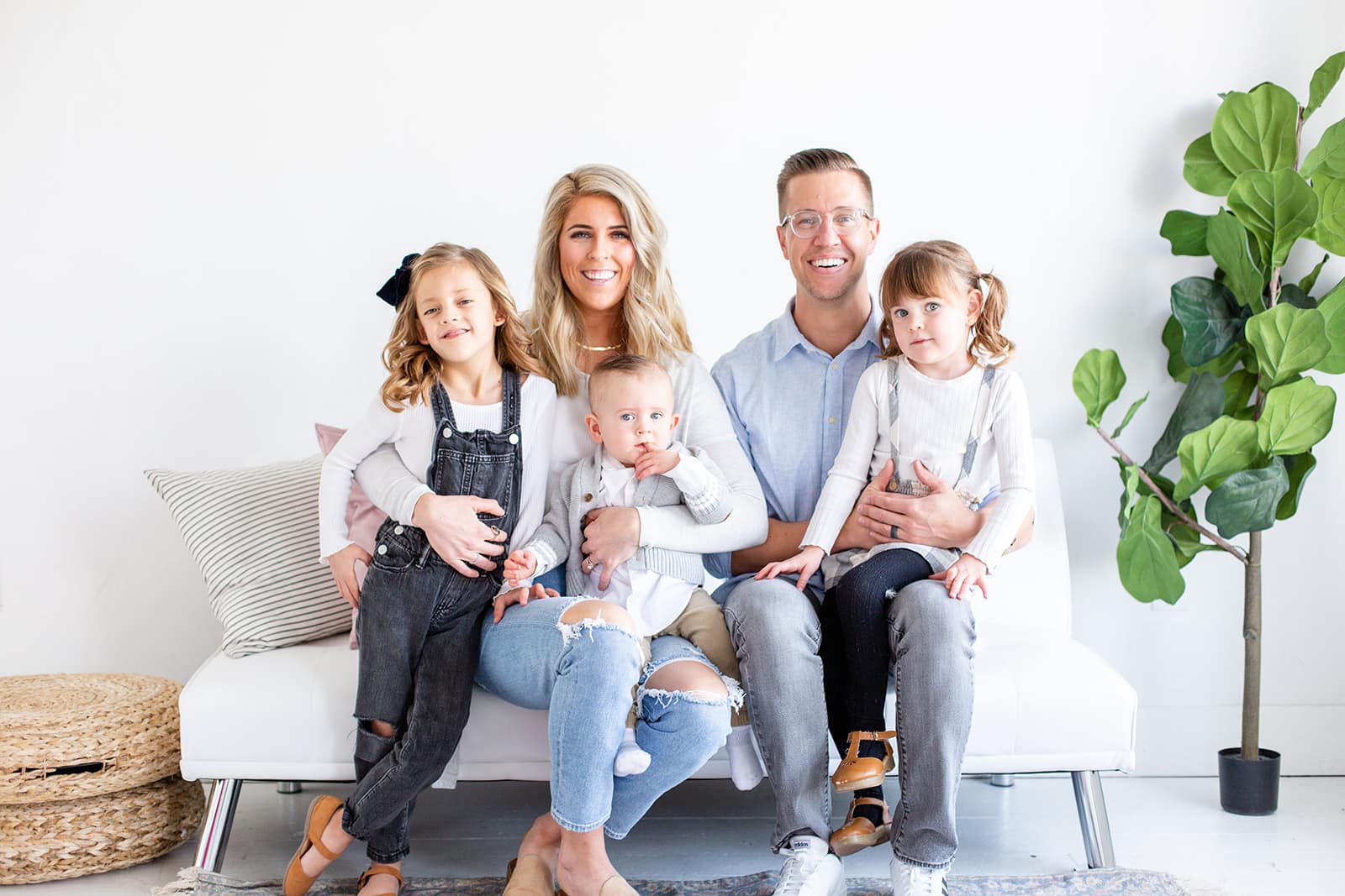 Dr. Curtis sitting with family on the couch. Orthodontist in Meridian, ID